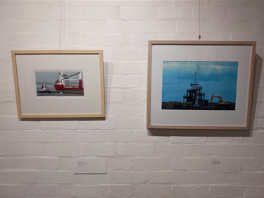 Artworks on the wall - Bob Stone's Tug Boat and a photograph of the corkscrew