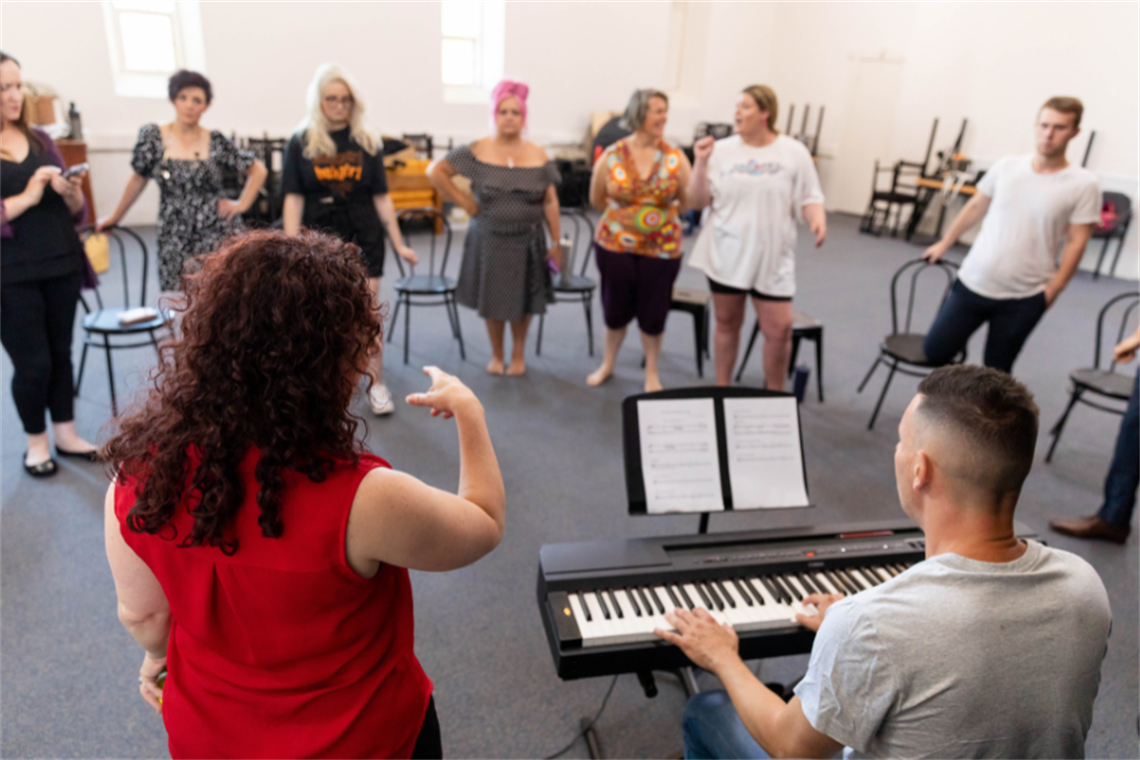 A group of people learning to sing together
