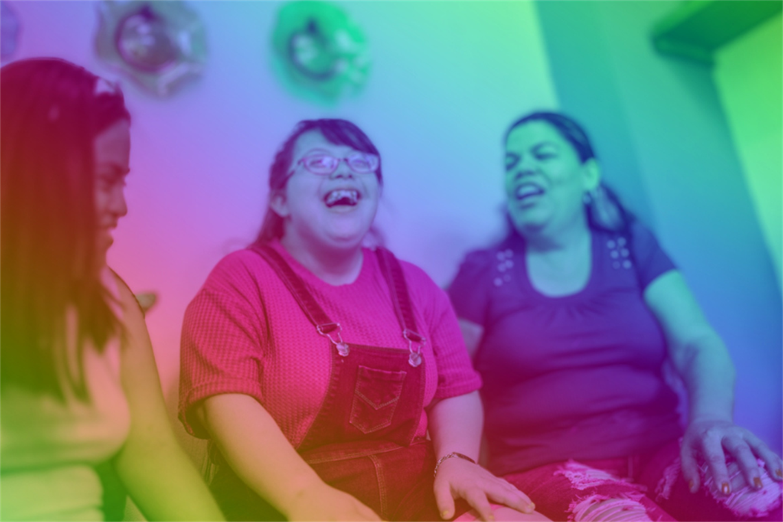 Three people smiling and laughing together
